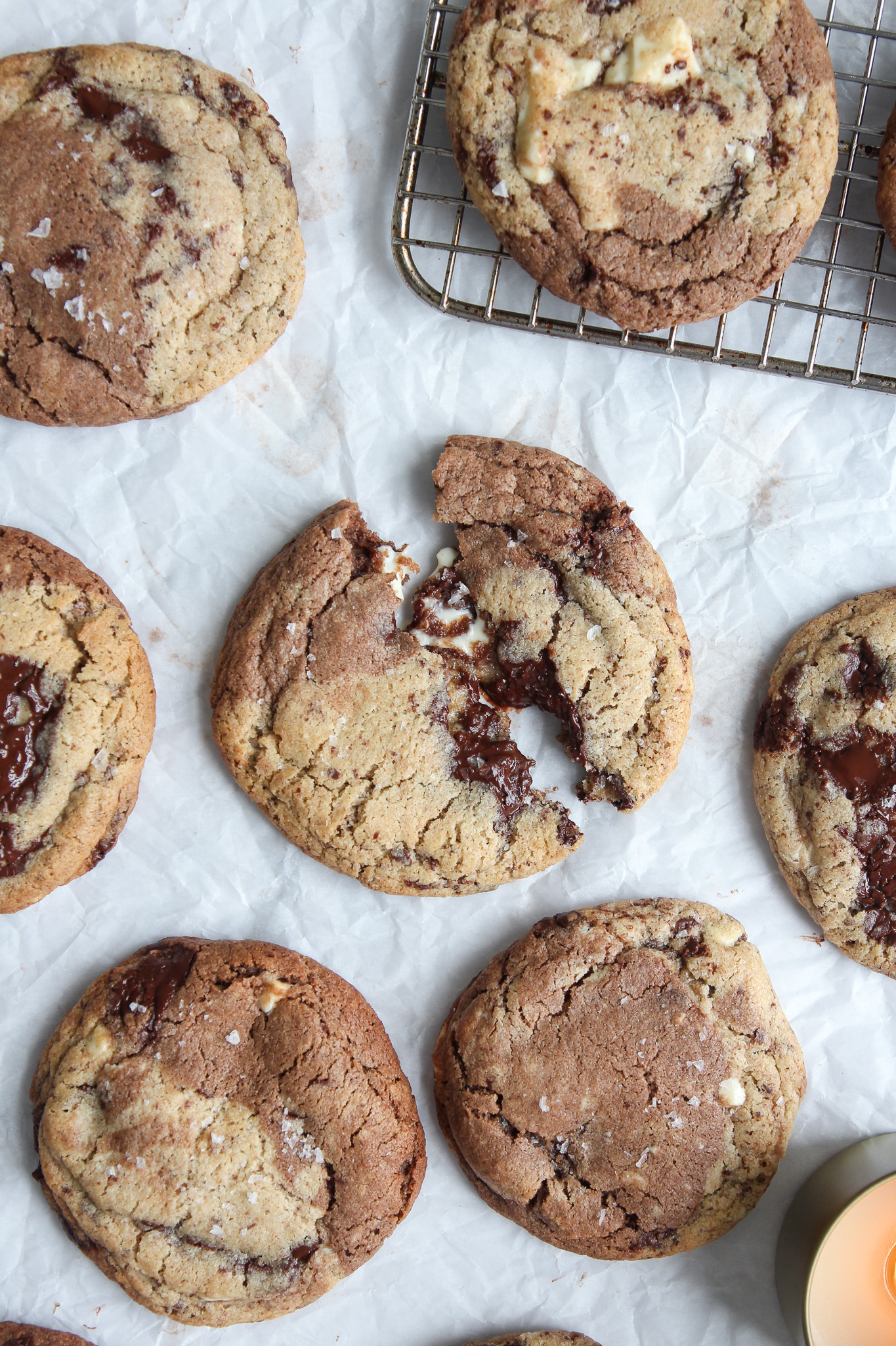 Gooey Marbled Miso Chocolate Chunk Cookies cooling on parchment paper.
